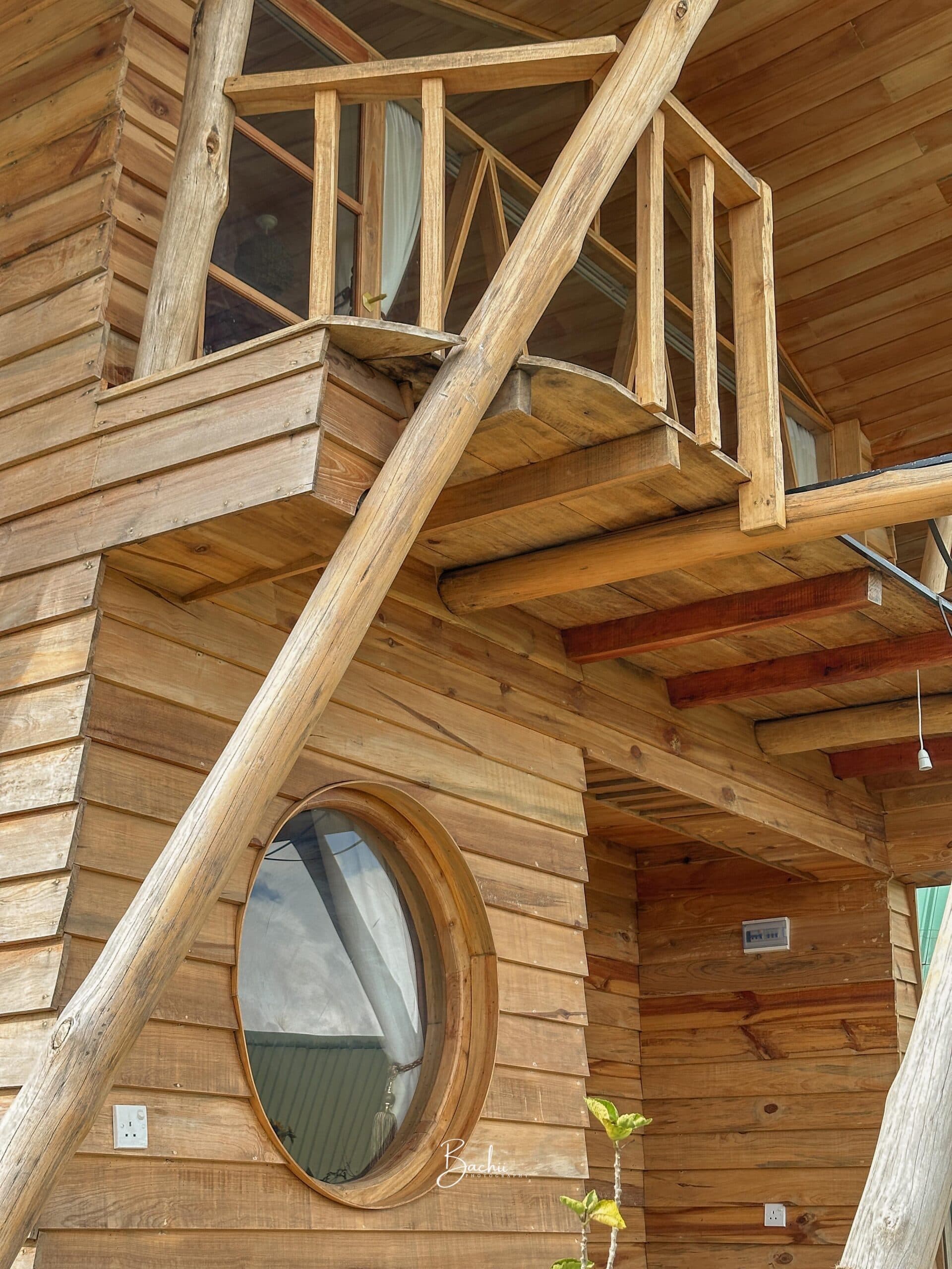 Birdeye cabin — the balcony and oval window on the upper floor