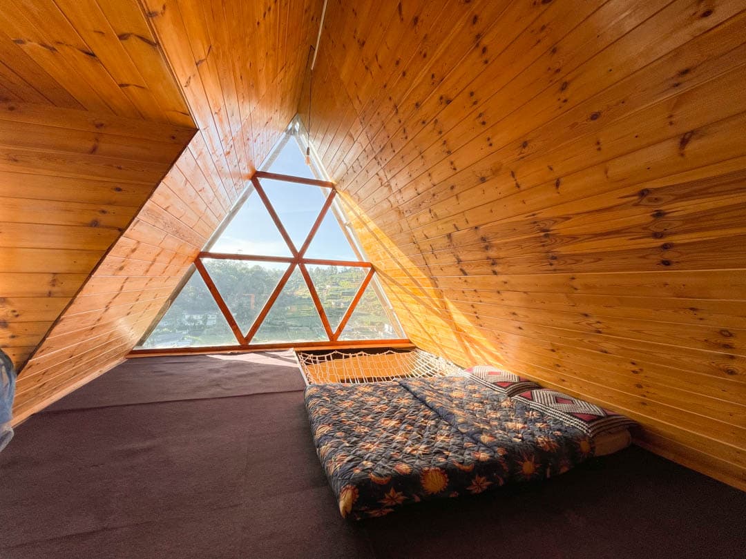 Yellow cabin — the hammock on the top floor, framed by the triangular window